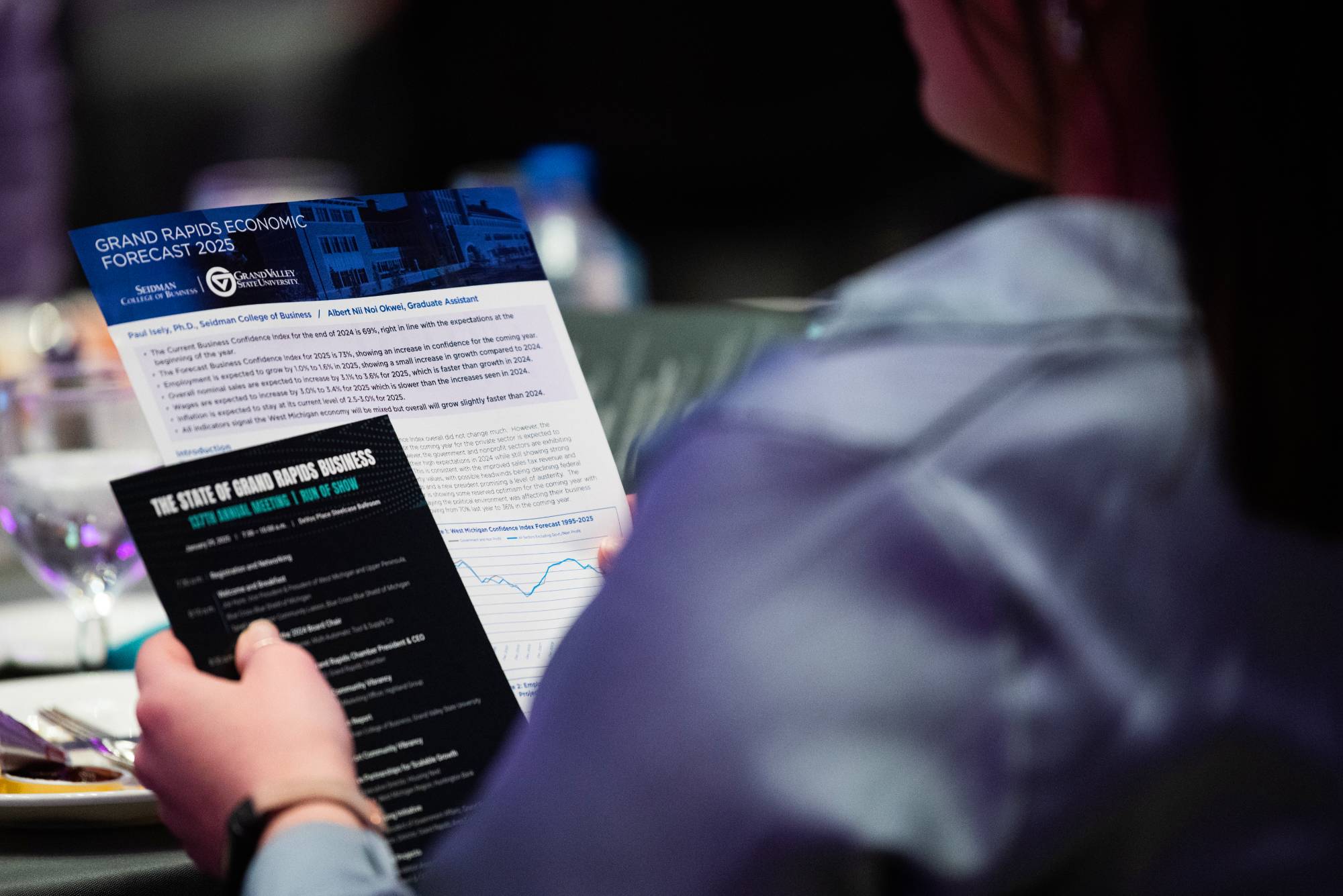 person holding pamphlets